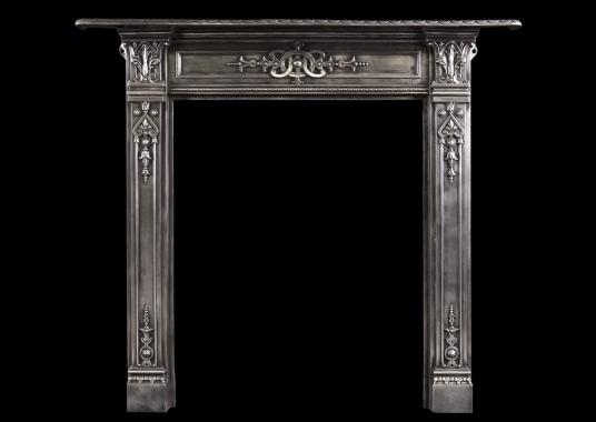 A petite polished cast iron fireplace