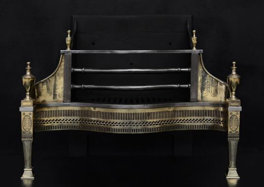 A polished brass fire basket in the Georgian style