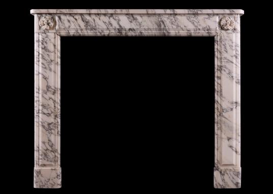 A petite French marble fireplace in the Louis XVI manner.