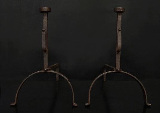 A pair of rustic wrought iron firedogs