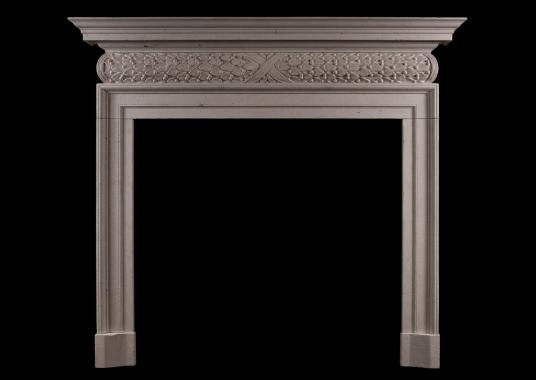 A mid 18th century style antiqued limestone fireplace