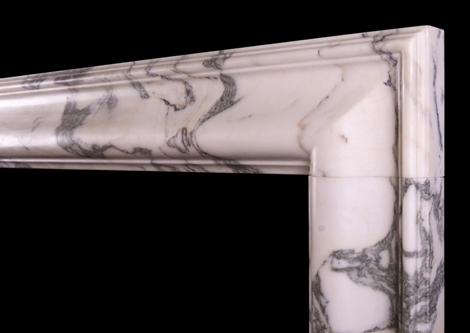 An English moulded bolection fireplace in Italian Arabescato marble