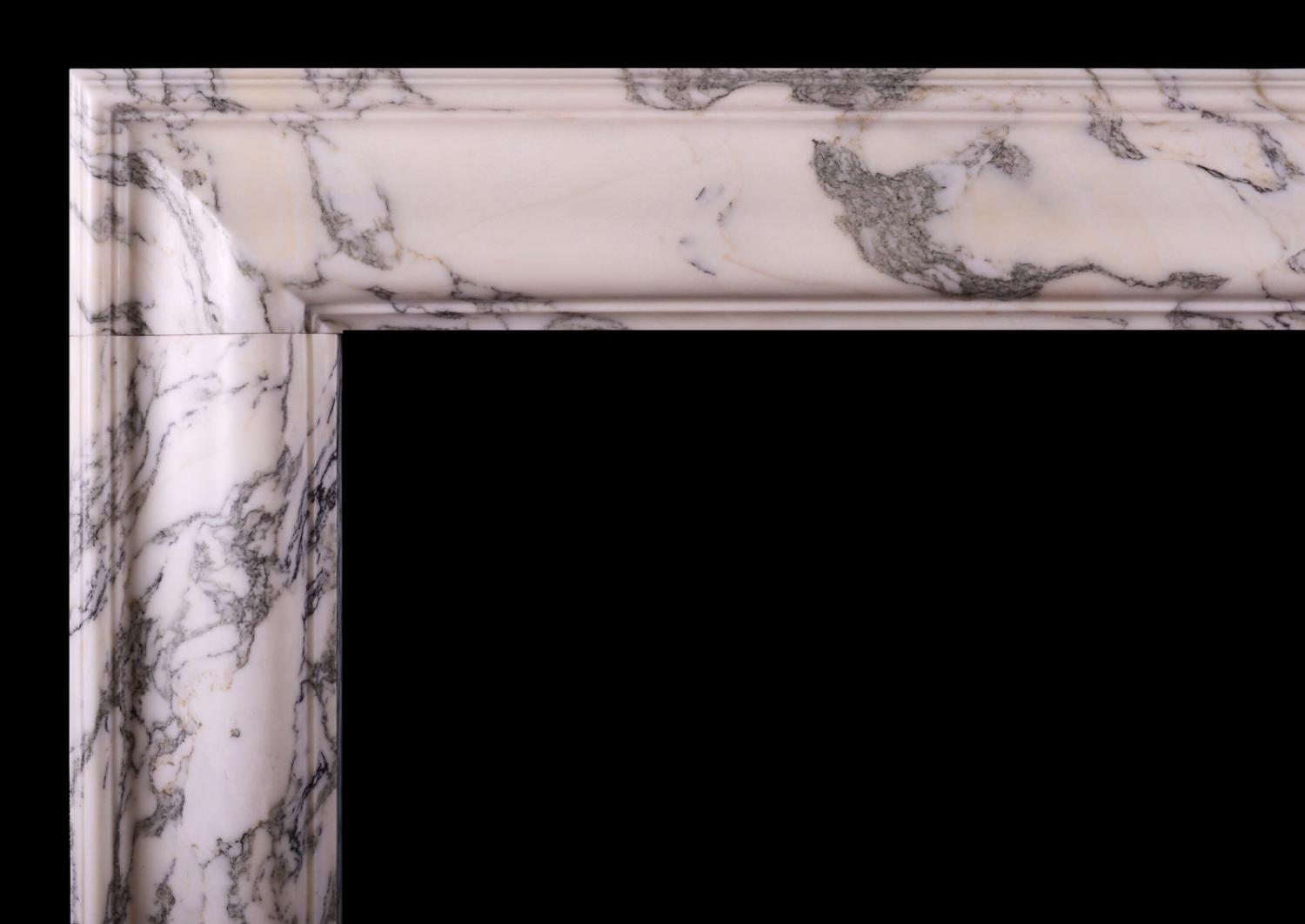 An English moulded bolection fireplace in Italian Arabescato marble