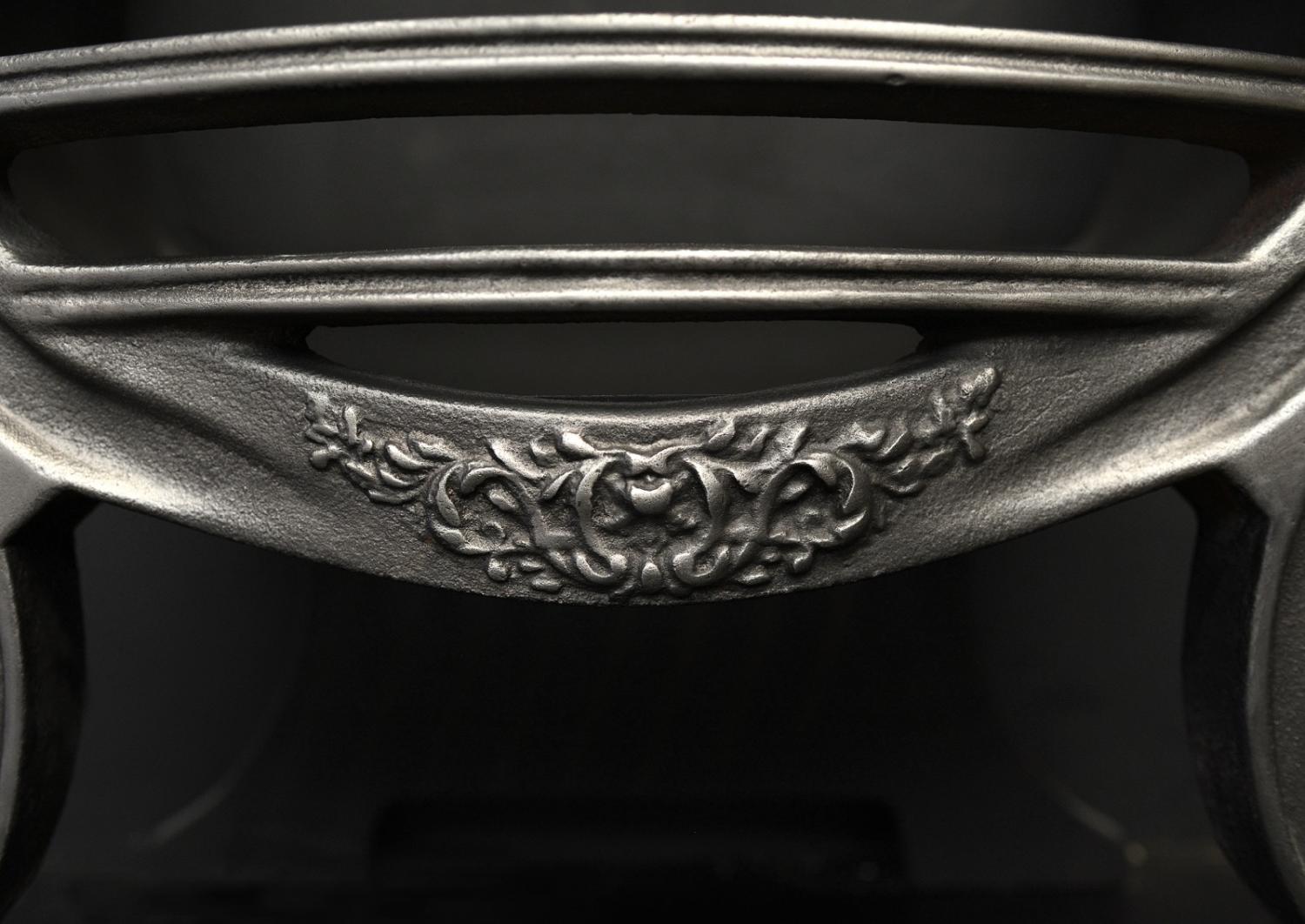 A polished cast iron Adam style basket